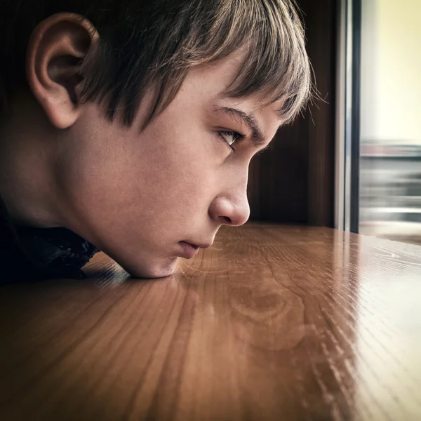 Triste adolescente pela janela — Fotografia de Stock