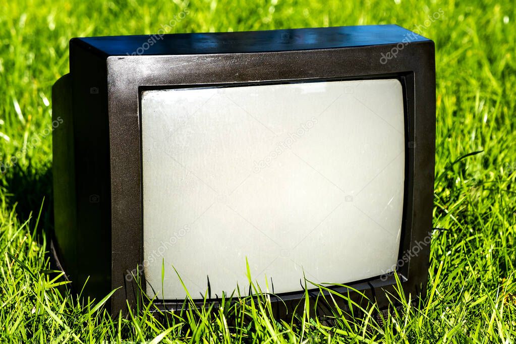 Old Analog Television Set on the Grass outdoor