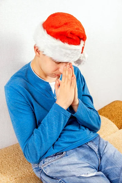 Young Man Santa Hat Praying White Wall Room — Stock Photo, Image