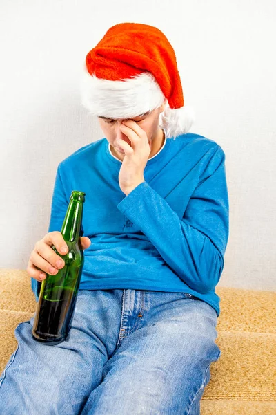 Sad Young Man Santa Hat Beer Bottle Sofa Room — Stock Photo, Image