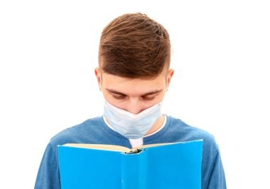 Young Man in Flu Mask read a Book on the White Background