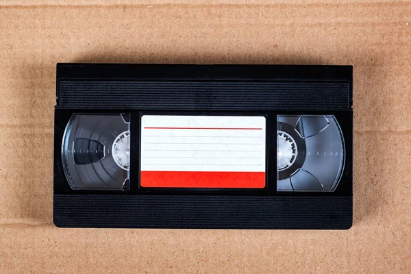 Retro Video Tape Cassette Cardboard Background Closeup — Stockfoto