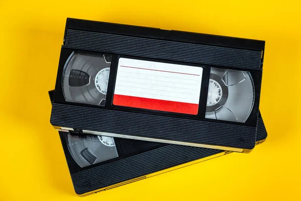 Two Retro Video Tape Cassette Yellow Paper Background — Stock Photo, Image