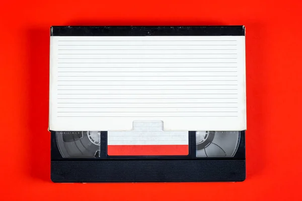 Retro Video Tape Cassette Box Red Paper Background — Stockfoto