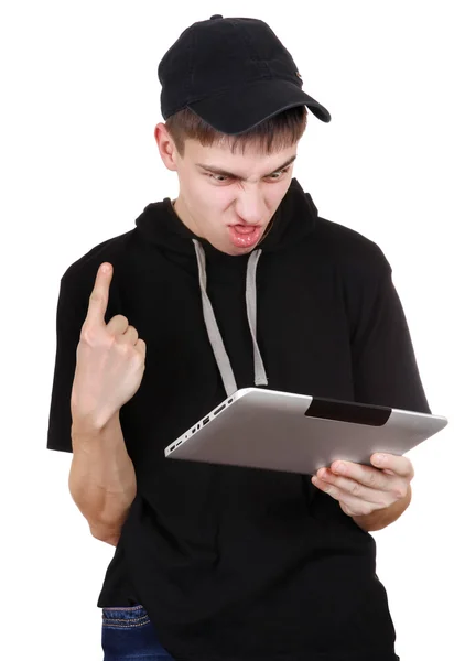 Раздражённый подросток с планшетом — стоковое фото