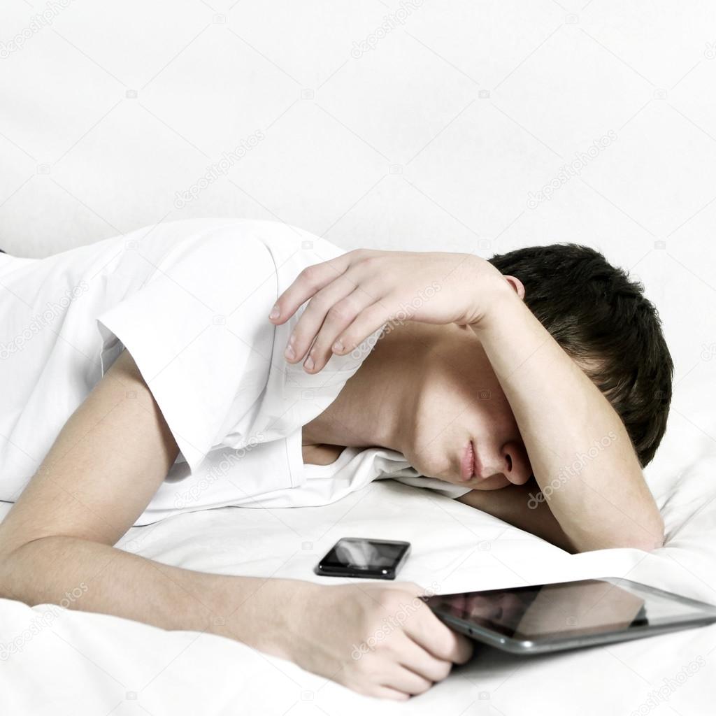 Teenager sleeps with Tablet Computer