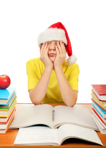 累了的小学生在圣诞老人的帽子 — 图库照片