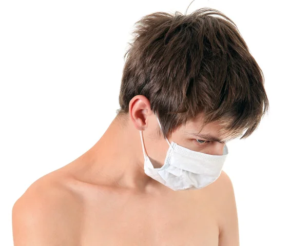 Trauriger junger Mann mit Grippe-Maske — Stockfoto