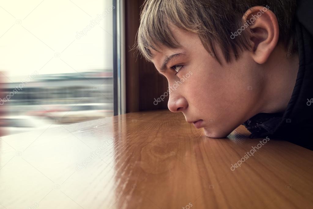 Sad Teenager look at Window