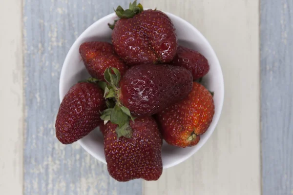 Fresh strawberry on a plate on a blue gray background — Stock Photo, Image