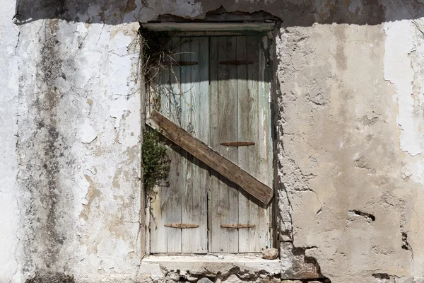 Old door in the stone walls of the village houses. Excellent background. — Stock Photo, Image