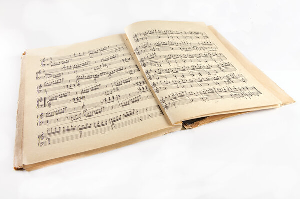 Old  music notes album on a white background