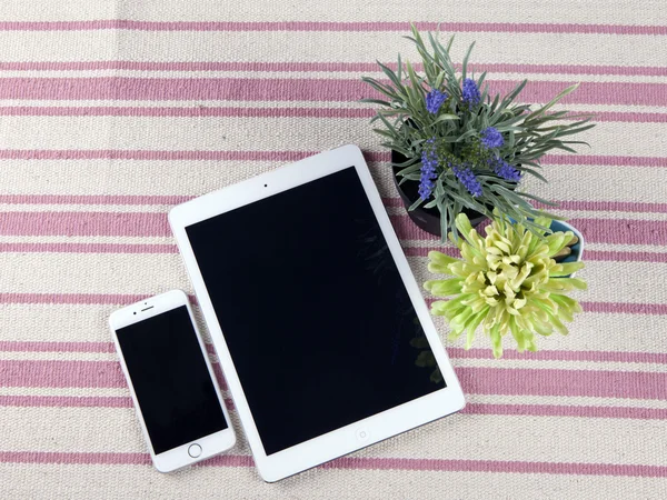 The composition of the tablets on a rustic rug with flowers — Stock Photo, Image