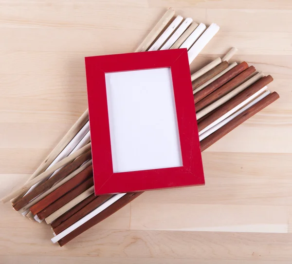 Beautiful composition with photo frames and fwooden sticks — Stock Photo, Image