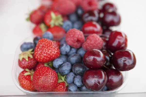 Fresh , raspberries, strawberries, cherries, blueberries in the box on the market — Stock Photo, Image