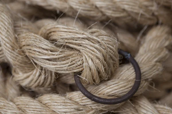 Coil of rope with a marine unit, and an iron ring. — Stock Photo, Image