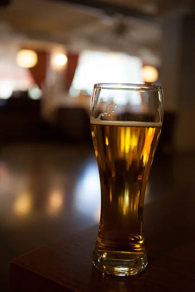 A glass of beer on the corner table in the restaurant — Stock Photo, Image