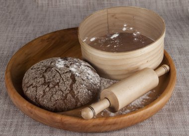 Fresh homemade bread made with a sieve for flour and a rolling pin.
