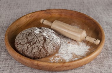Fresh homemade bread made with  a rolling pin.