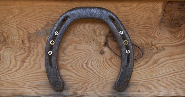 Old horseshoe hanging on the wooden wall. — Stock Photo, Image