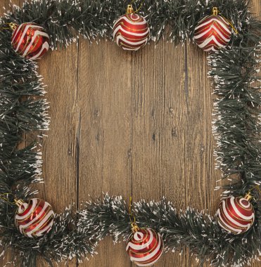 Christmas card with a fringe of branches of Christmas trees and festive toys on branches