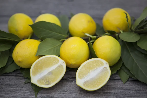 Branch af friske saftige sicilianske citroner på en træbaggrund - Stock-foto