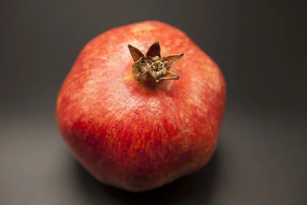 Spanish juicy ripe pomegranate closeup on a dark background — Stock Photo, Image