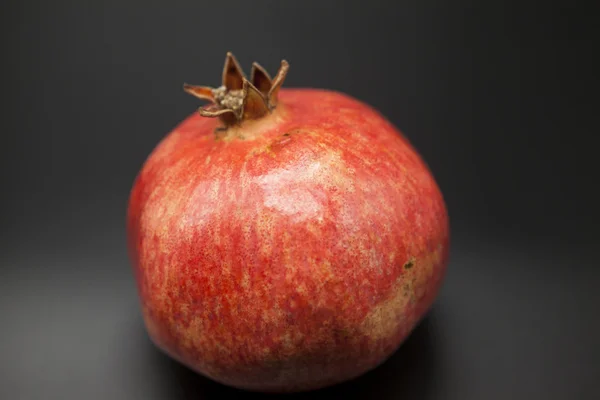 Spanish juicy ripe pomegranate closeup on a dark background — Stock Photo, Image