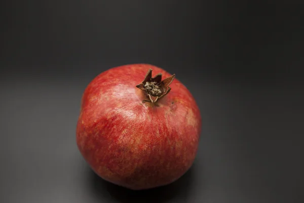 Spanish juicy ripe pomegranate closeup on a dark background — Stock Photo, Image