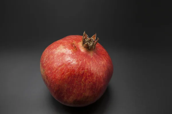 Spanish pomegranate on a dark background. — Stock Photo, Image