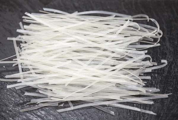 Beautiful homemade Japanese rice noodles from durum wheat on stone background, closeup — 스톡 사진