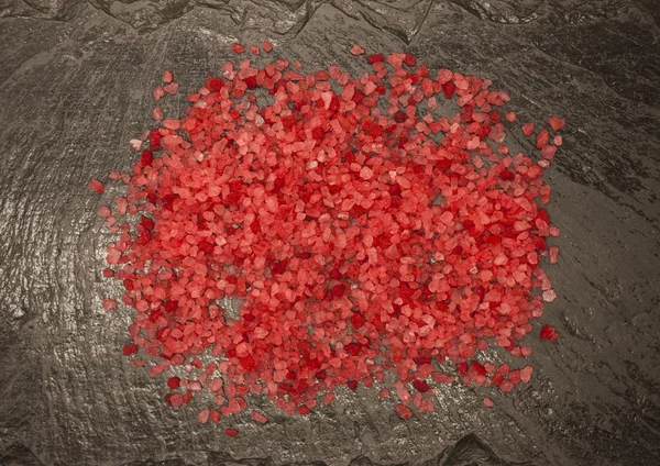 Coarse brightly pink food salt from Sri Lanka on a stone background — Stock Fotó