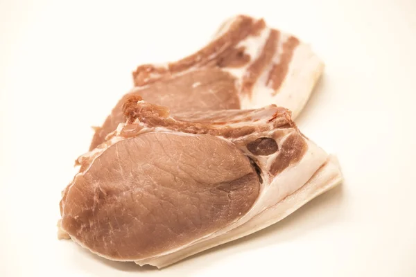 Pieces of fresh raw pork appetizing close-up on a white background. — Stock Photo, Image