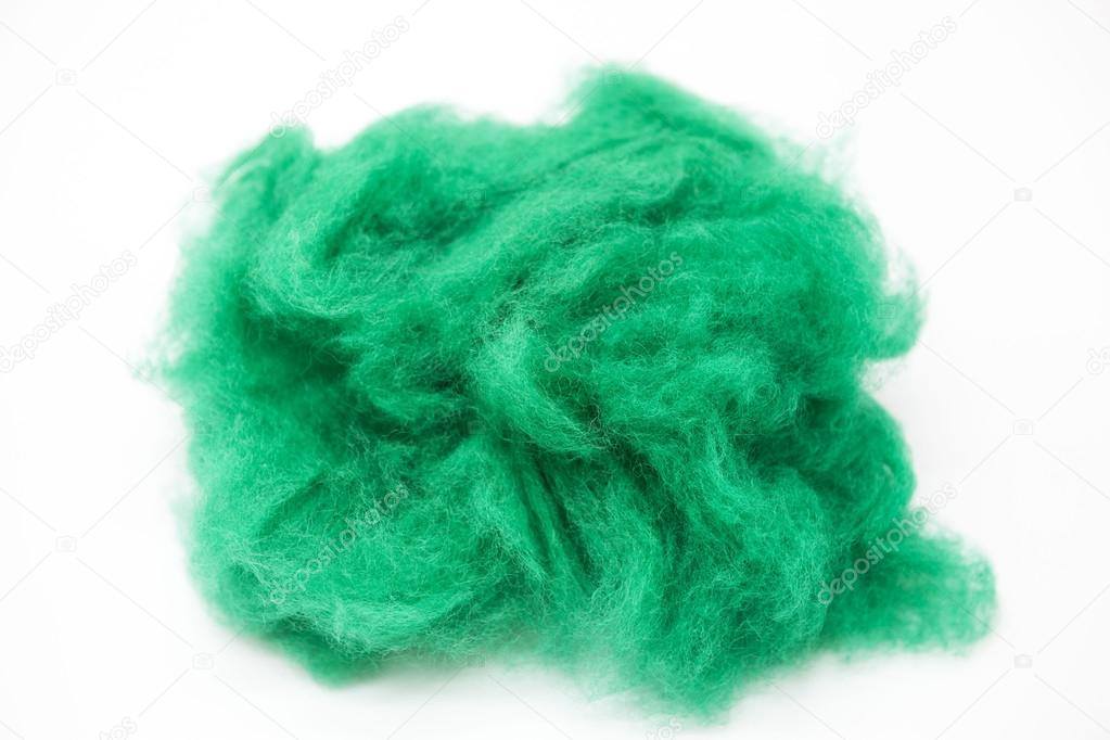 Emerald  green piece of Australian sheep wool Merino breed close-up on a white background