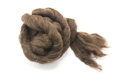 Brownpiece of Australian sheep wool Merino breed close-up on a white background