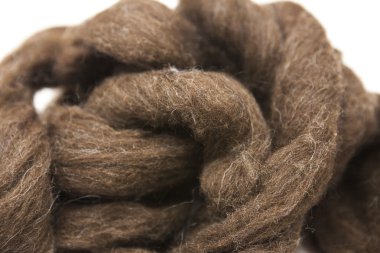 Brownpiece of Australian sheep wool Merino breed close-up on a white background