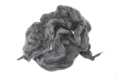 Gray piece of Australian sheep wool Merino breed close-up on a white background