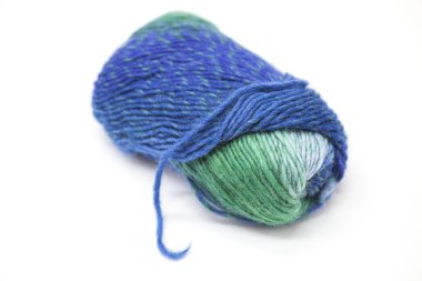 Green blue ball of wool yarn for knitting close up on a white background.