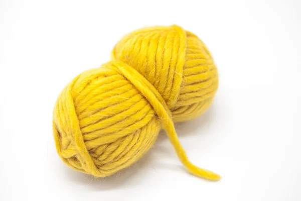 Bola amarela de fios de lã para tricotar de perto em um fundo branco . — Fotografia de Stock