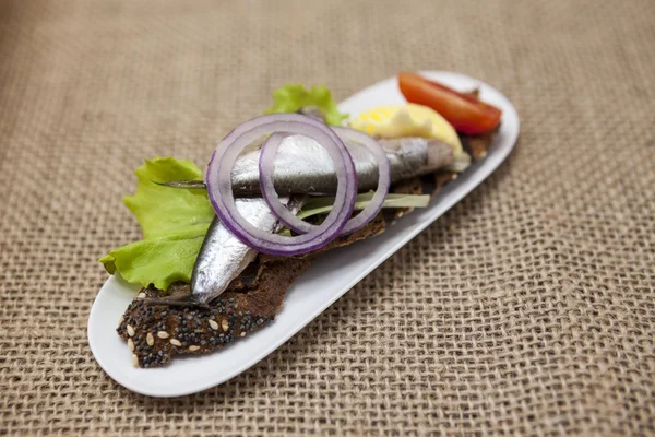 Νόστιμη Ισπανική Τάπας με βούτυρο και το κρεμμύδι σαλάτα σαρδελόρεγγα, Ατλαντικού σε μπαγκέτα φέτα. Ένα άριστο υπόβαθρο για το μενού, καφέ, εστιατόριο. — Φωτογραφία Αρχείου