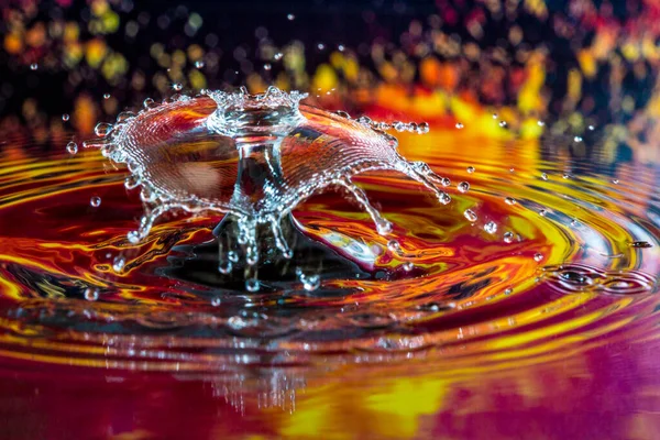 Crown on top of un umbrella after a crystal water drop collision