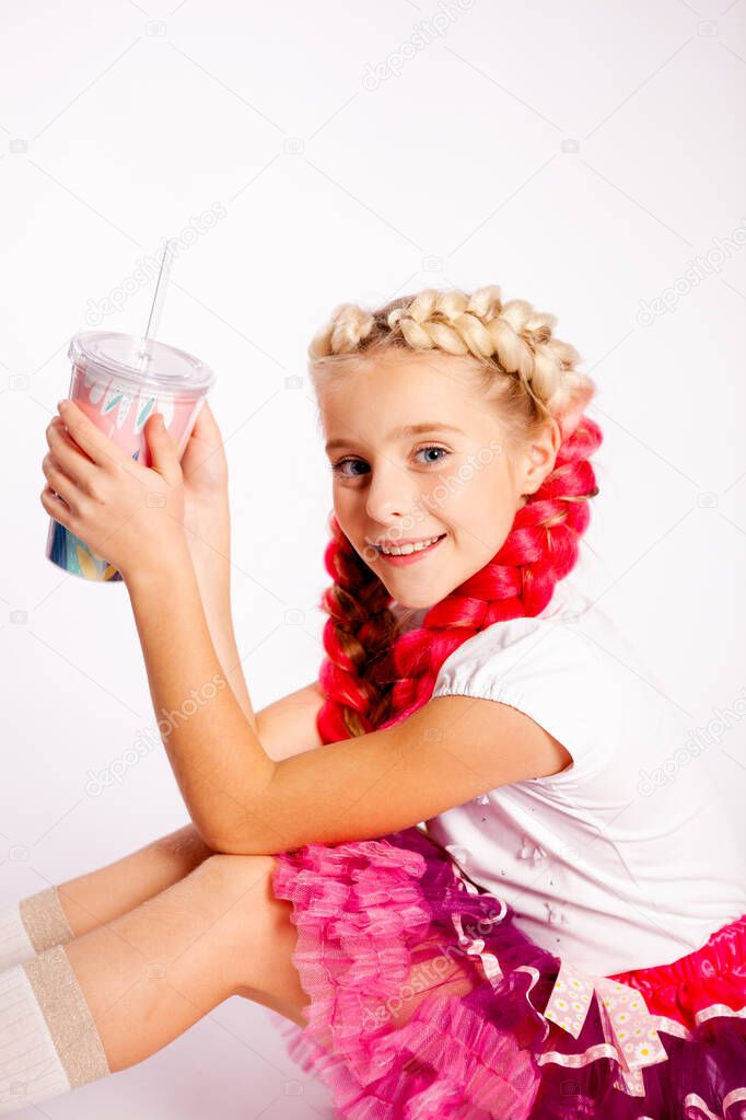 cute girl with bright pigtails in white clothes on a white background