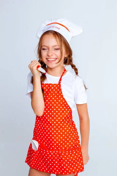 girl in a chef's cap and apron for cooking