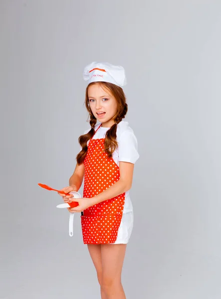 girl in a chef\'s cap and apron for cooking