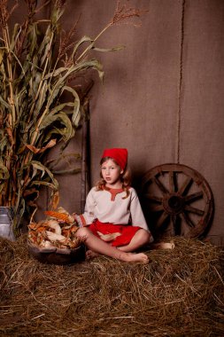 Açık keten gömlekli bir kız ve kırsal tarzda kırmızı bir eşarp.