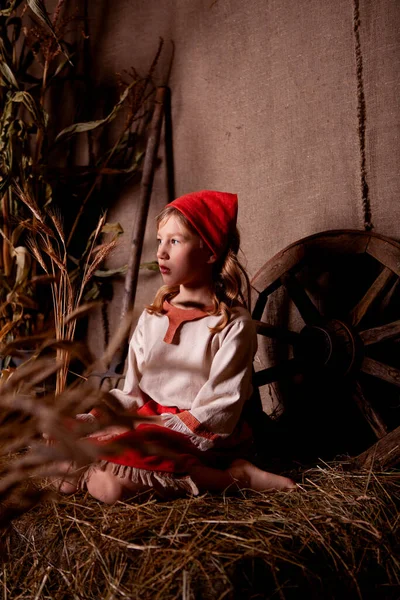 Açık keten gömlekli bir kız ve kırsal tarzda kırmızı bir eşarp.