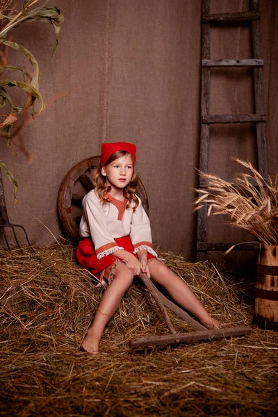 girl in a light linen shirt and a red scarf in a rustic style