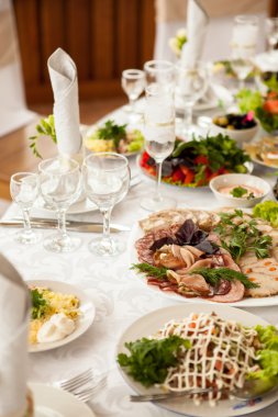 holiday table with salads, sliced meat