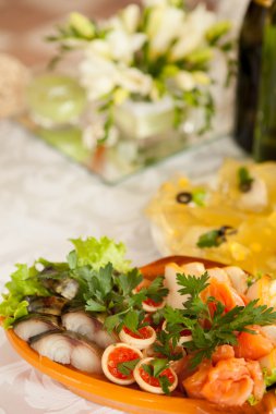 part of the festive table with pieces of smoked fish and salmon 