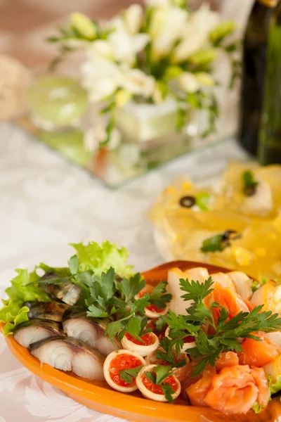 Part of the festive table with pieces of smoked fish and salmon Stock Picture